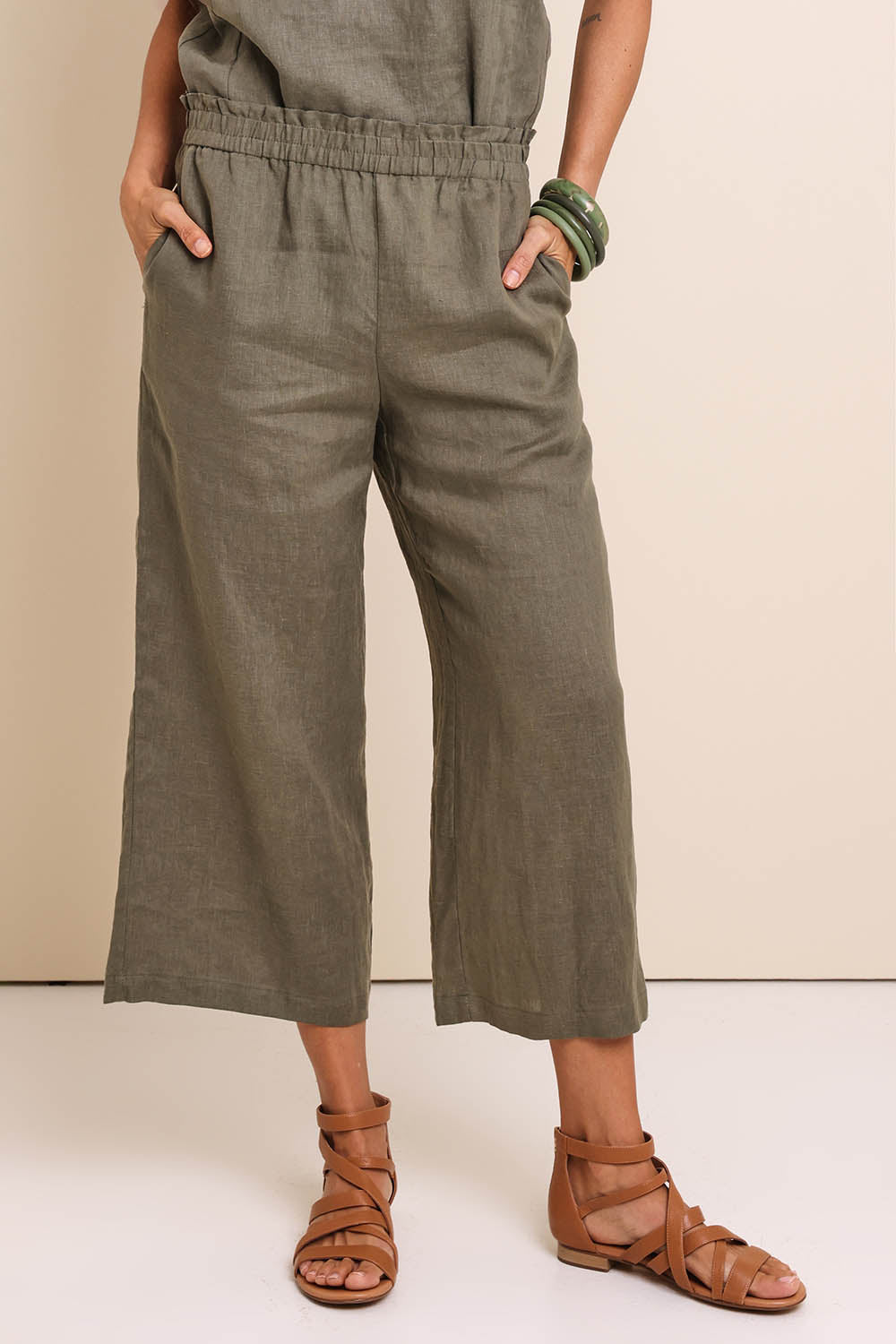 Model Amandam wearing size 10 of the Belle Easy Wear Linen Pant – Olive in colour Olive, in a cropped view