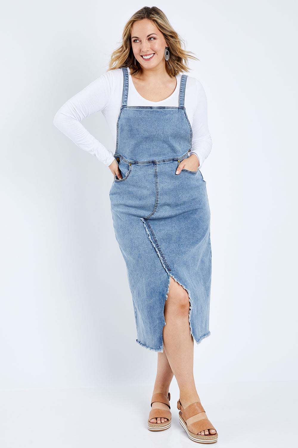 Model Jess wearing size 14 of the Happy Me Denim Pinny in colour Denim (Blue), from the front, showing the whole outfit