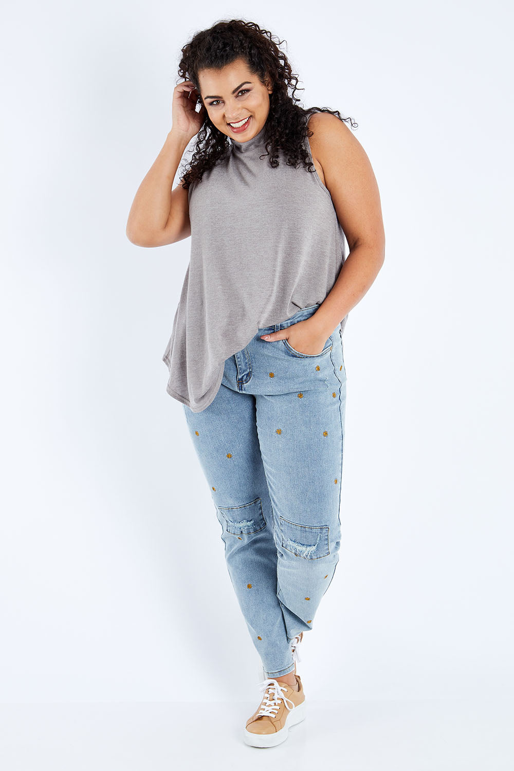 Model Sasha-Lee wearing size 16 of the Paper Daisy High Waisted Jeans in colour Denim (Blue), from the front, showing the whole outfit