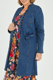 Model Fiona wearing size 16 of the Attention To Me Denim Jacket in colour Denim (Blue), from the front, cropped image