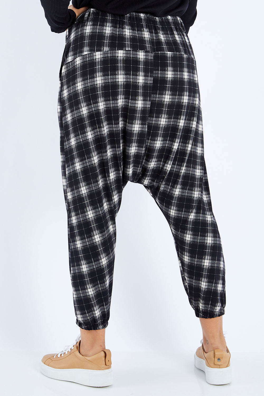 Model Sasha-Lee wearing size 16 of the Check Me Out Pants in colour Black (Black), from the back
