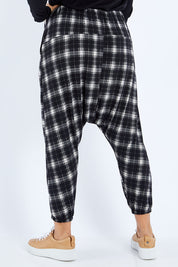Model Sasha-Lee wearing size 16 of the Check Me Out Pants in colour Black (Black), from the back