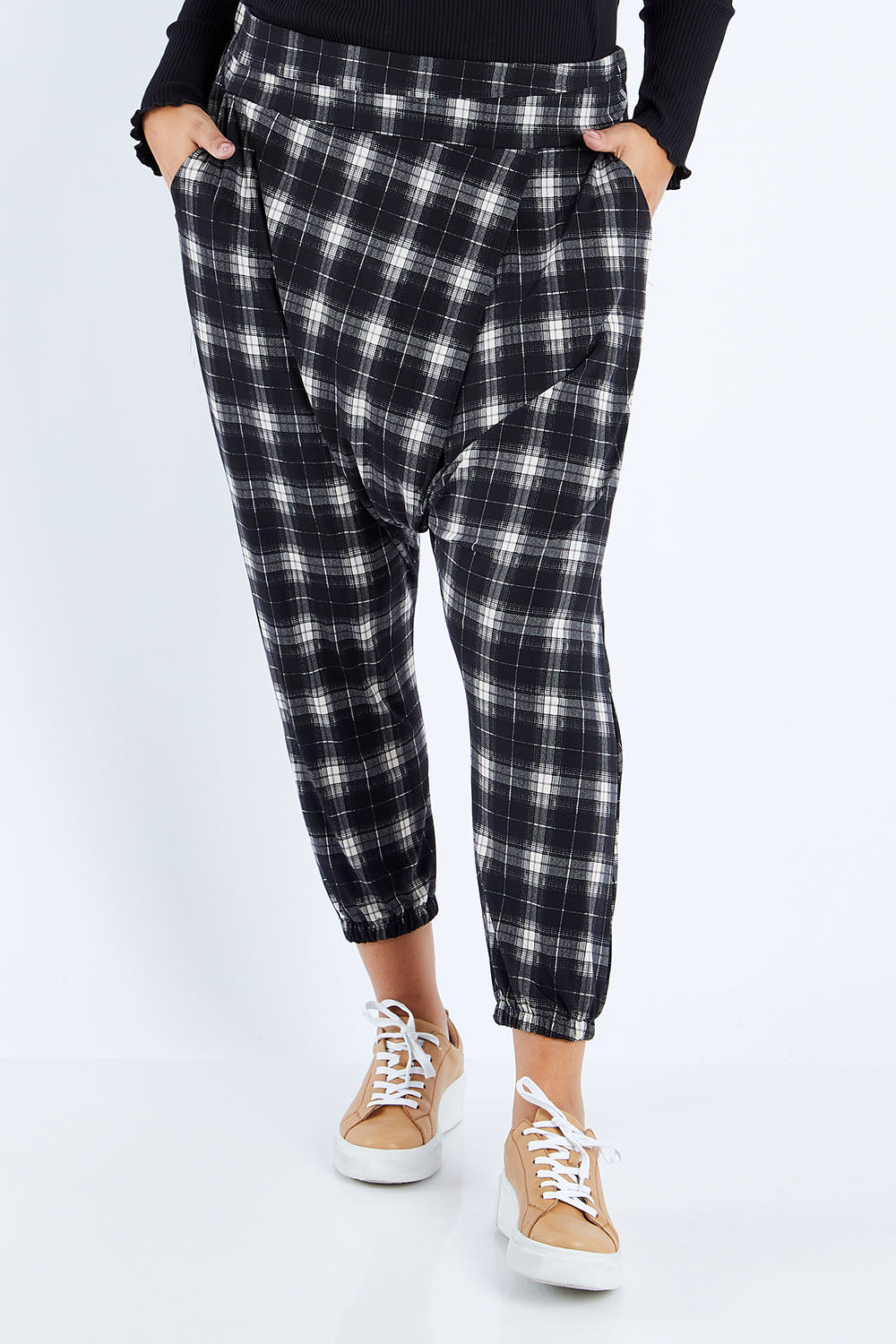 Model Sasha-Lee wearing size 16 of the Check Me Out Pants in colour Black (Black), from the front, cropped image