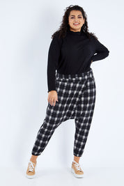 Model Sasha-Lee wearing size 16 of the Check Me Out Pants in colour Black (Black), from the front, showing the whole outfit