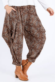 Model Laura wearing size 14 of the Tied To You Comfort Pants in colour Leopard, from the front, cropped image
