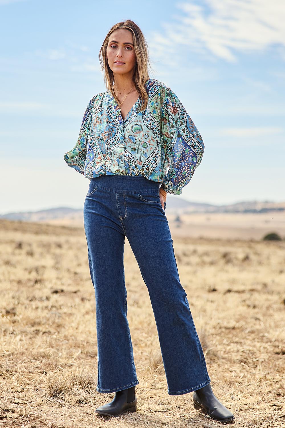 Model Tegan wearing size 10 of the Easy As Plain Pull On Jeans in colour Darkdenim (Blue), from the front, showing the whole outfit