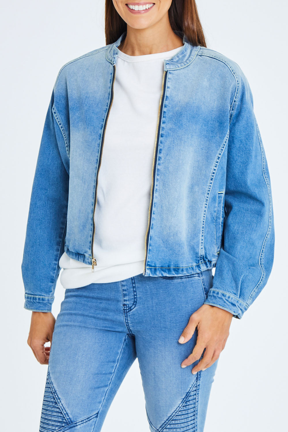 Model Cara wearing size 10 of the Give Me Wings Denim Jacket in colour Denim (Blue), from the front, cropped image