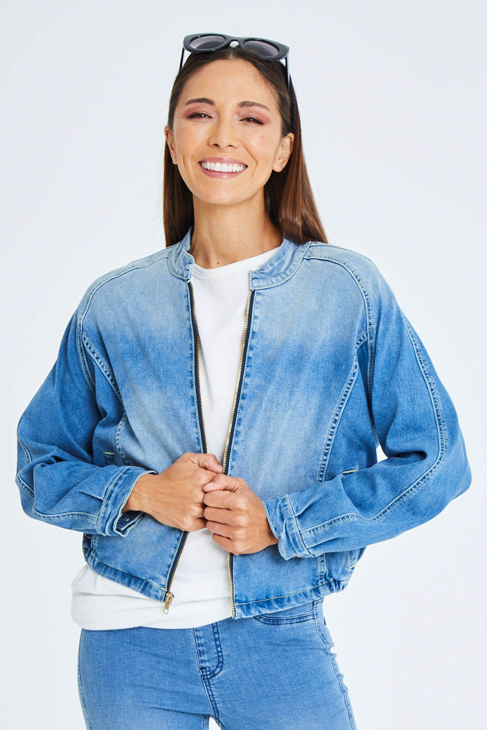 Model Cara wearing size 10 of the Give Me Wings Denim Jacket in colour Denim (Blue), from the front, cropped image