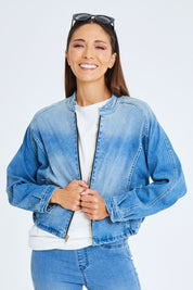 Model Cara wearing size 10 of the Give Me Wings Denim Jacket in colour Denim (Blue), from the front, cropped image