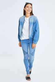 Model Cara wearing size 10 of the Give Me Wings Denim Jacket in colour Denim (Blue), from the front, showing the whole outfit