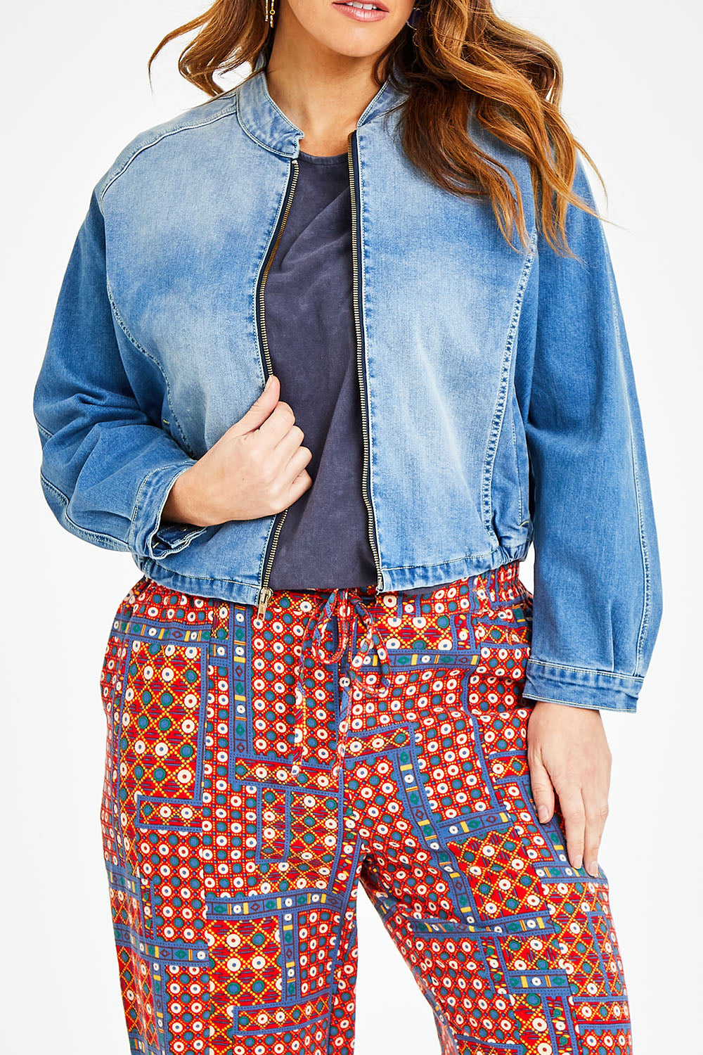 Model Laura wearing size 14 of the Give Me Wings Denim Jacket in colour Denim (Blue), from the front, cropped image