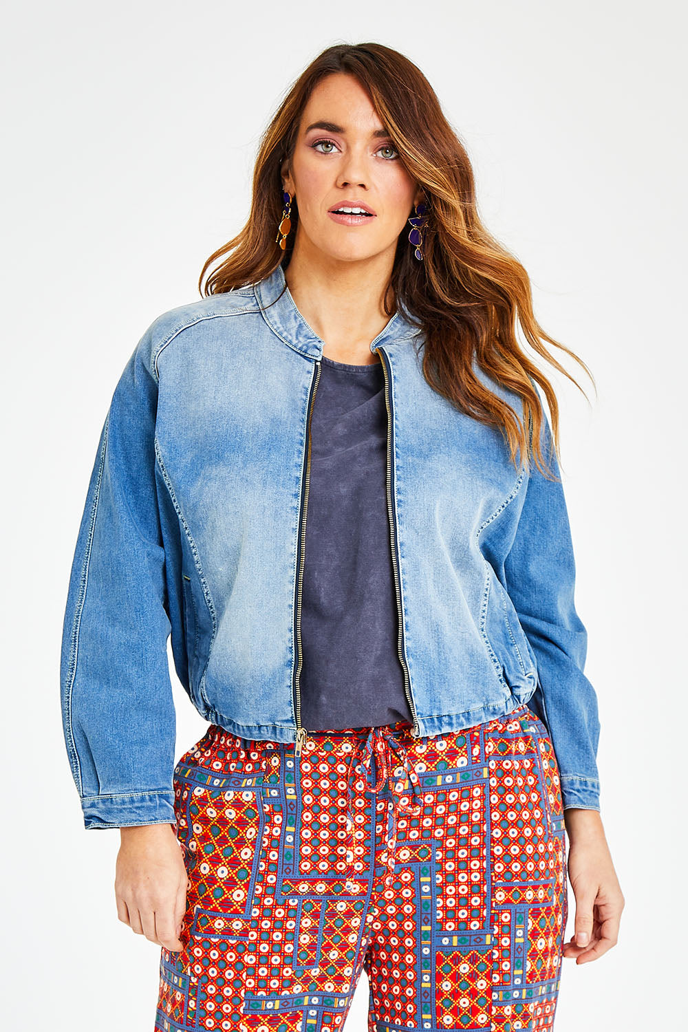 Model Laura wearing size 14 of the Give Me Wings Denim Jacket in colour Denim (Blue), from the front, cropped image