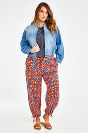Model Laura wearing size 14 of the Give Me Wings Denim Jacket in colour Denim (Blue), from the front, showing the whole outfit