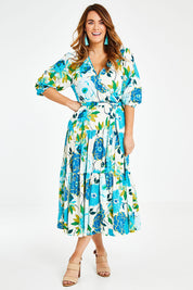 Model Laura wearing size 14 of the Here Comes The Sun Dress in colour Bluegreen (Blue), from the front, showing the whole outfit