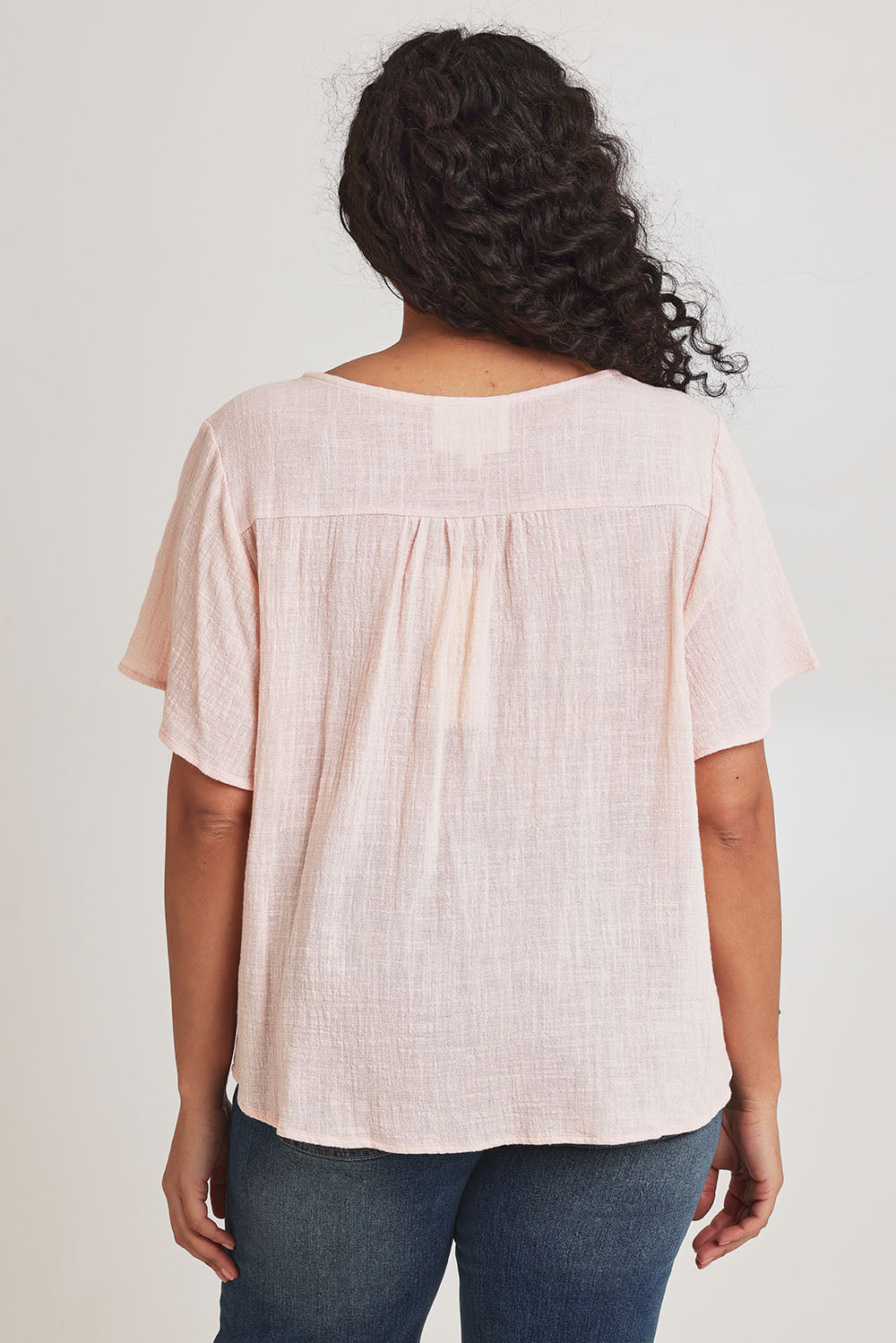 Model Terri-Leigh wearing size 14 of the Cute As A Button Blouse in colour Blush (Pink), from the back