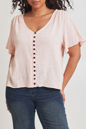 Model Terri-Leigh wearing size 14 of the Cute As A Button Blouse in colour Blush (Pink), from the front, cropped image