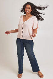 Model Terri-Leigh wearing size 14 of the Cute As A Button Blouse in colour Blush (Pink), from the front, showing the whole outfit