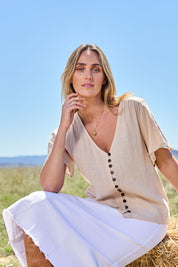 Model Tegan wearing size 10 of the Cute As A Button Blouse in colour Natural, from the front, showing the whole outfit