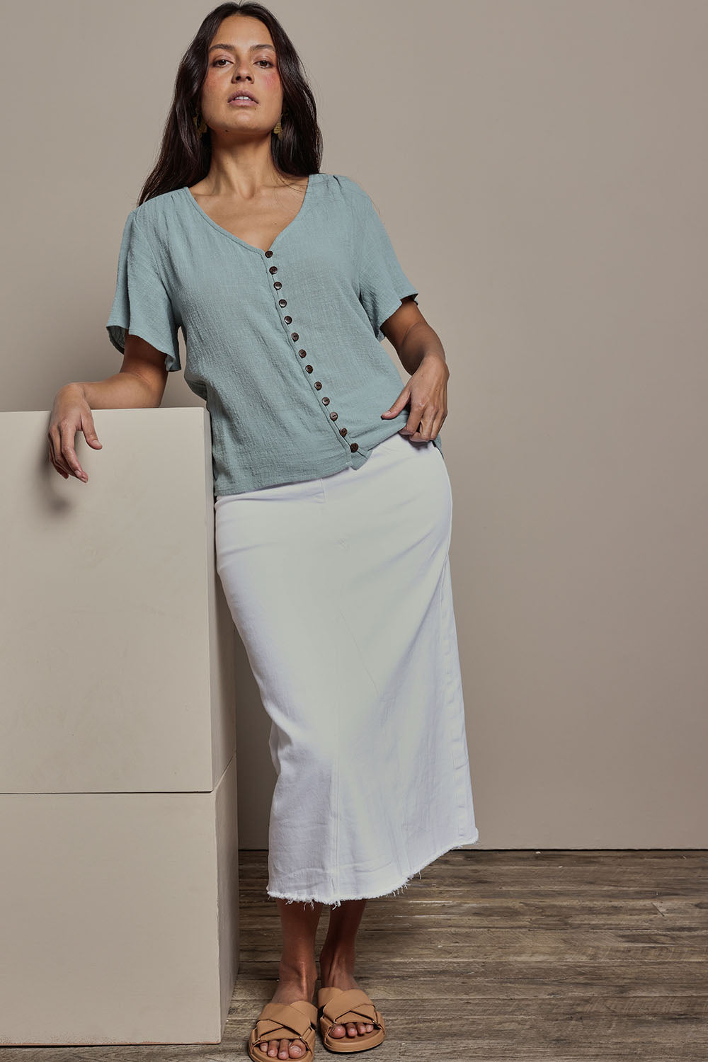 Model Tahnee wearing size 10 of the Cute As A Button Blouse in colour Sage (Green), from the front, showing the whole outfit