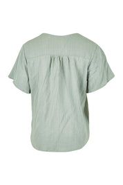 Product shot of the Cute As A Button Blouse in colour Sage (Green), from the back