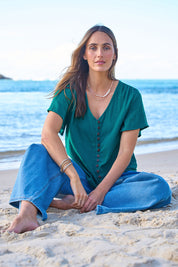 Model Tegan wearing size 10 of the Cute As A Button Blouse in colour Teal (Green), from the front, showing the whole outfit