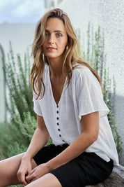 Model Tegand wearing size 10 of the Cute As A Button Cotton Blouse - White in colour White, in a cropped view