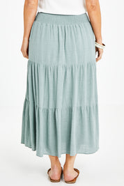 Model Laura wearing size 14 of the Cute As A Button Skirt in colour Sage (Green), from the back