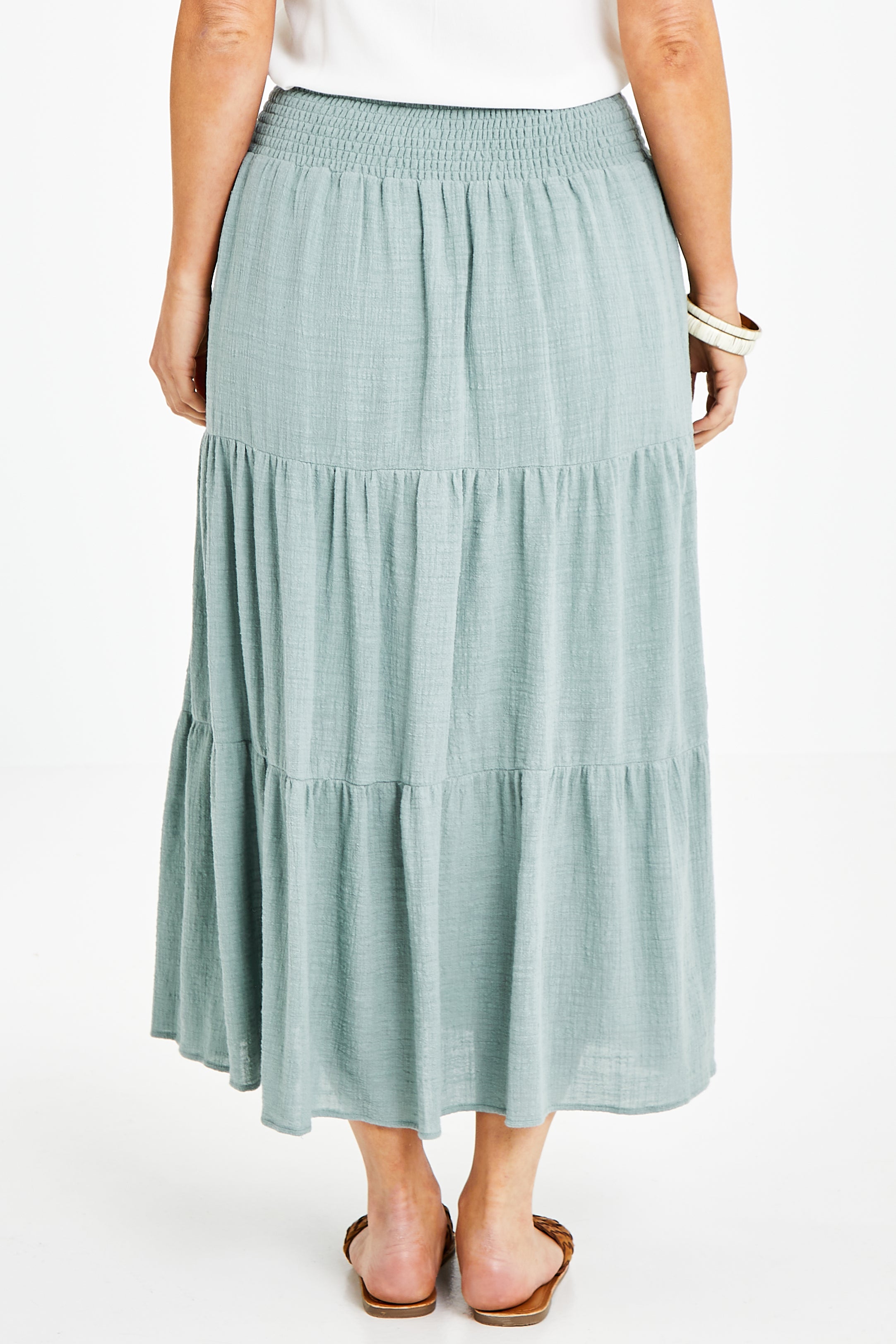 Model Laura wearing size 14 of the Cute As A Button Skirt in colour Sage (Green), from the back