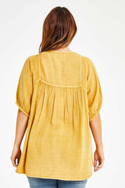 Model Laura wearing size 14 of the Daydreaming In Sunshine Blouse in colour Sunflower, from the back