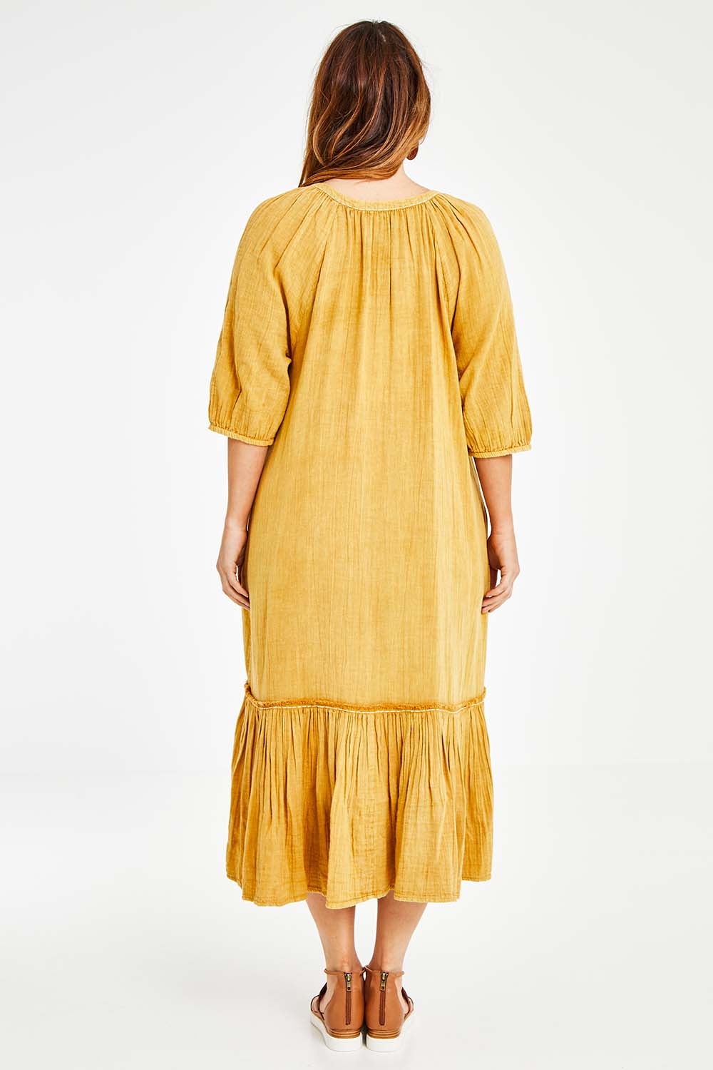 Model Laura wearing size 14 of the Daydreaming In Sunshine Dress in colour Sunflower, from the back