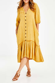 Model Laura wearing size 14 of the Daydreaming In Sunshine Dress in colour Sunflower, from the front, cropped image
