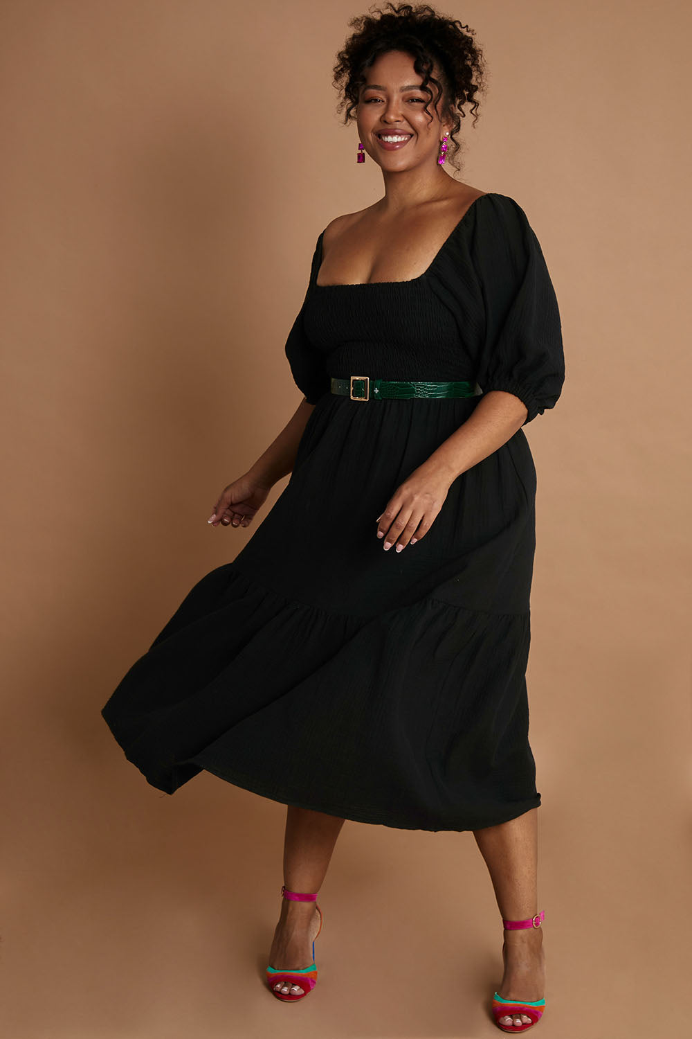Model Alexis wearing size 16 of the Wandering In Fields Organic Cotton Dress in colour Black (Black), from the front, showing the whole outfit