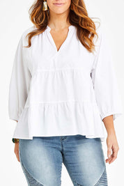 Model Laura wearing size 14 of the Cruising On By Tiered Blouse in colour White (White), from the front, cropped image