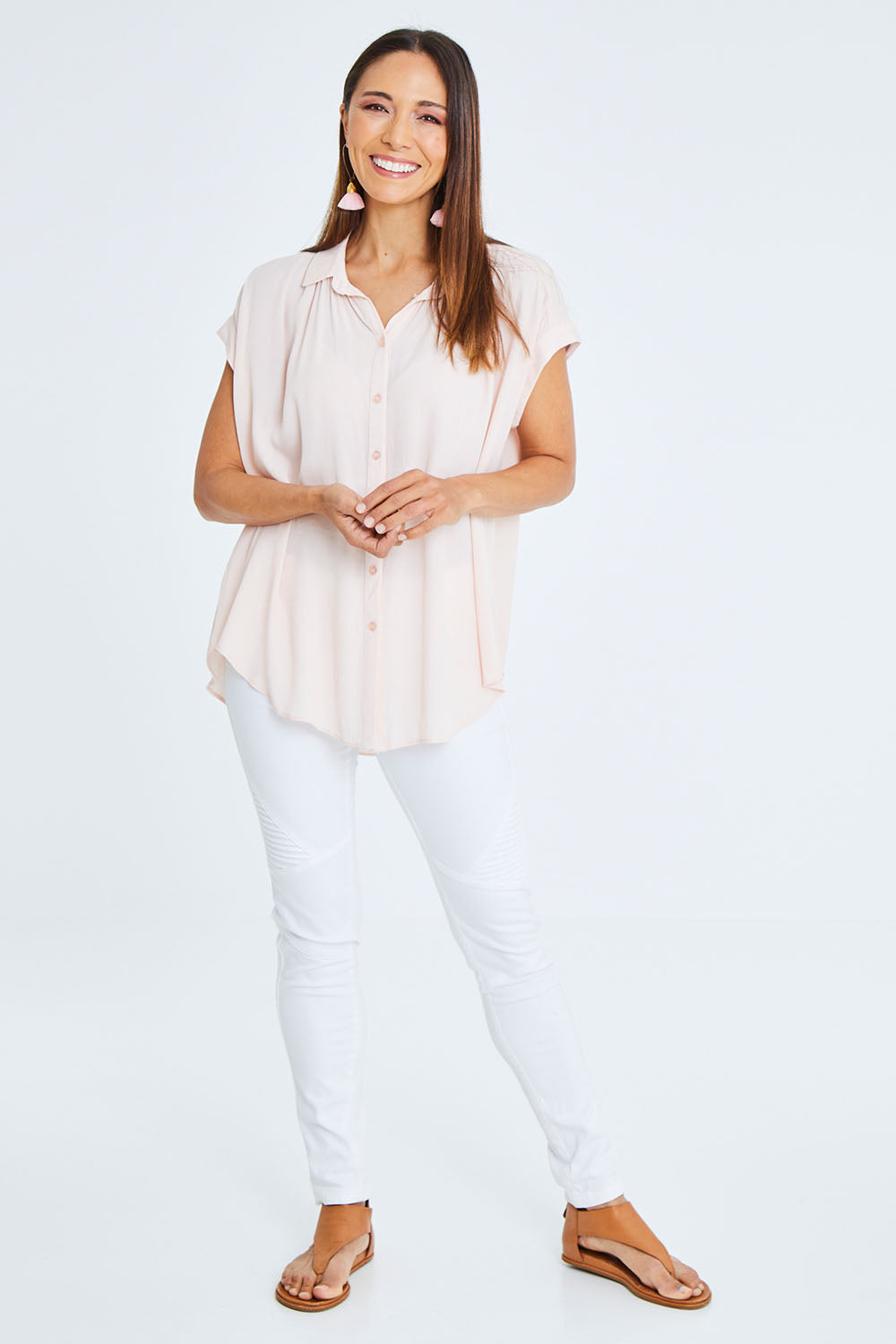 Model Cara wearing size 10 of the Go Your Own Way Button Blouse in colour Blush (Pink), from the front, showing the whole outfit