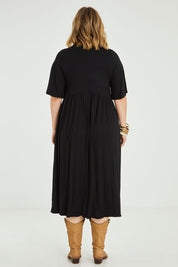 Model Jess wearing size 14 of the Swinging Hands With You Dress in colour Black (Black), from the back