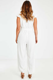Model Laura wearing size 14 of the I See You Jumpsuit in colour Ivory (White), from the back