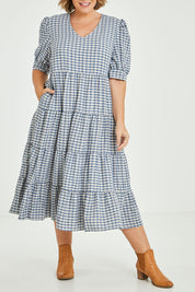 Model Fiona wearing size 16 of the Tiers Of Delight Dress in colour Bluecheck (Blue), from the front, cropped image