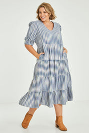 Model Fiona wearing size 16 of the Tiers Of Delight Dress in colour Bluecheck (Blue), from the front, showing the whole outfit