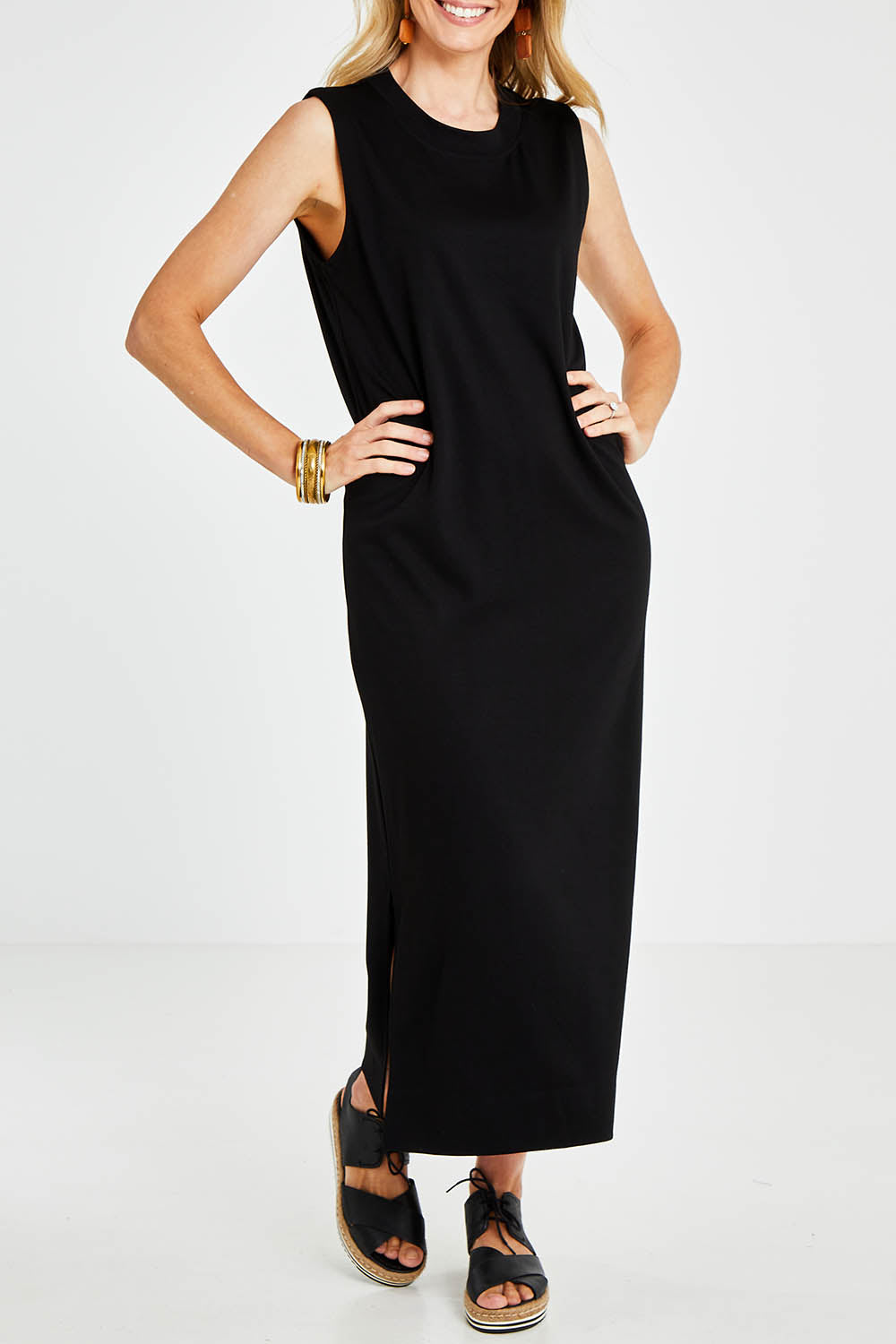Model Kelly wearing size 10 of the Ready For Anything Tank Dress in colour Black (Black), from the front, cropped image