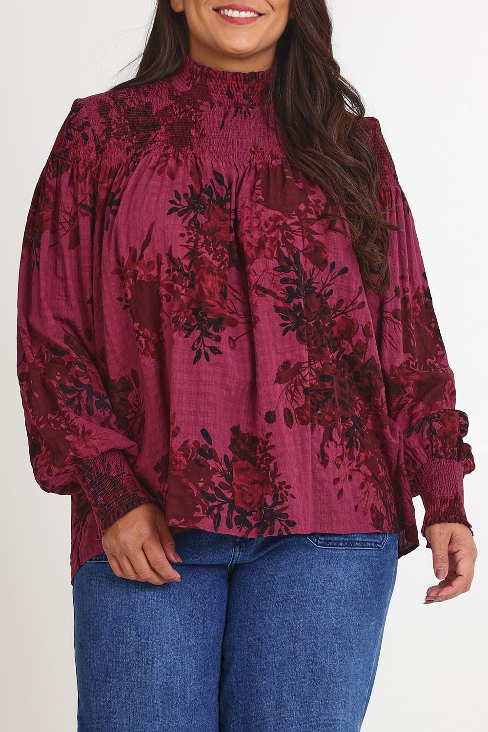 Model Ashleigh wearing size 16 of the Romance In The Air Blouse in colour Shiraz (Purple), from the front, cropped image