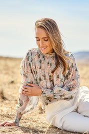 Model Tegan wearing size 10 of the Romance In The Air Blouse in colour Skyfleur (Blue), from the front, showing the whole outfit
