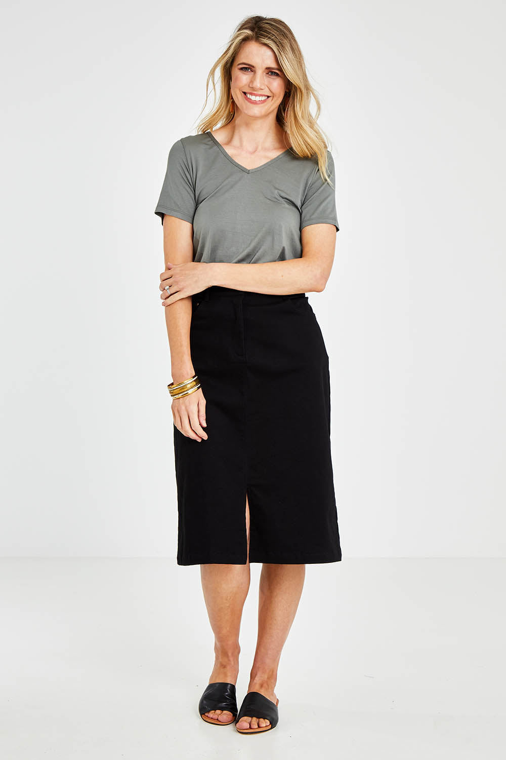 Model Kelly wearing size 10 of the Hold My Hand Denim Skirt in colour Black (Black), from the front, showing the whole outfit