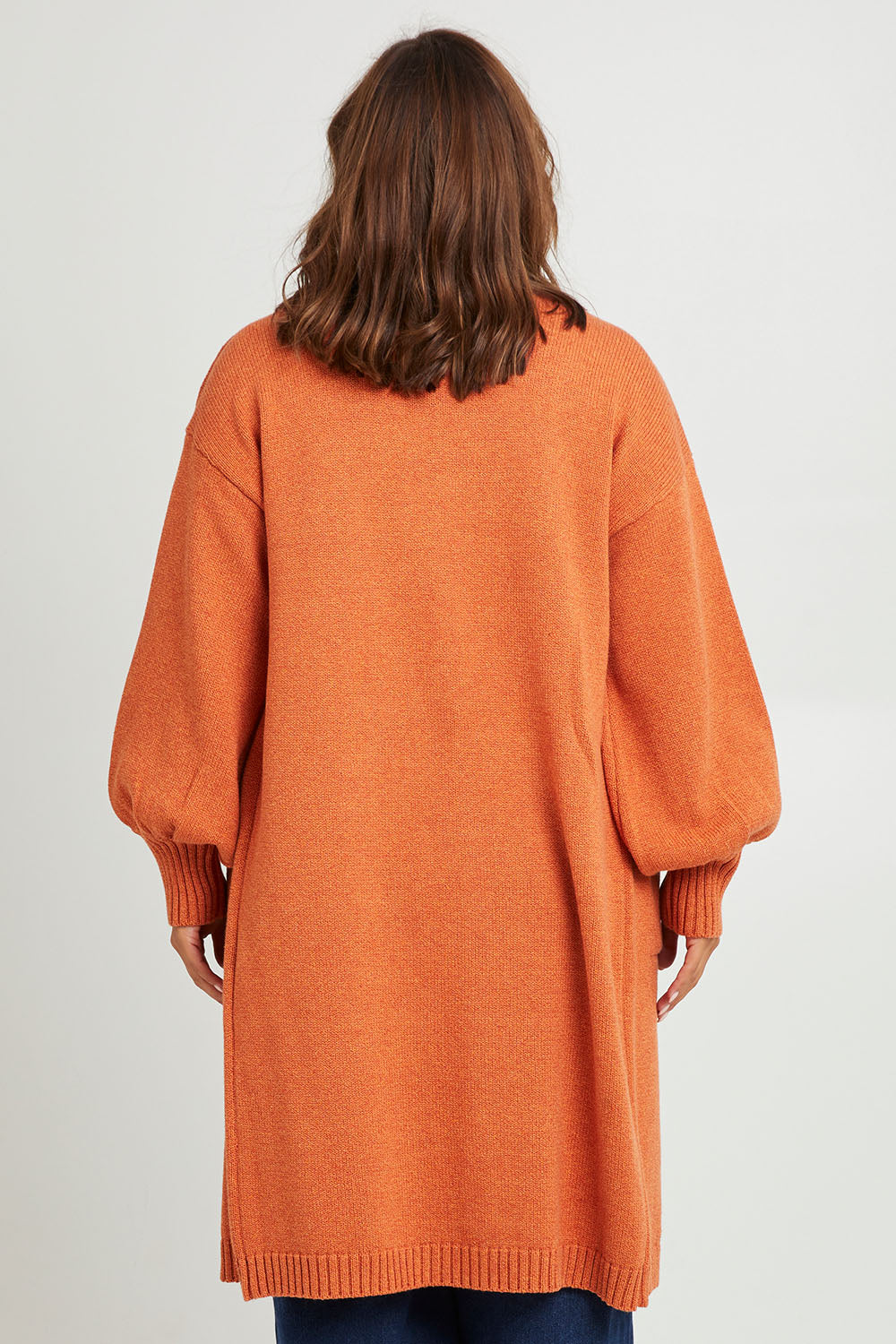 Model Monique wearing size L of the A True Jewel Cardi in colour Rust, from the back