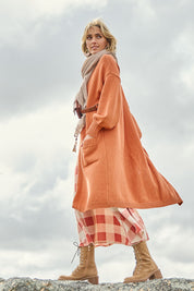 Model Tegan wearing size S of the A True Jewel Cardi in colour Rust, from the front, showing the whole outfit