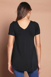 Model Madeline wearing size 10 of the Softly Swinging Bamboo Tee in colour Black (Black), from the back