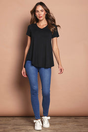 Model Nadia wearing size 10 of the Softly Swinging Bamboo Tee in colour Black (Black), from the front, showing the whole outfit