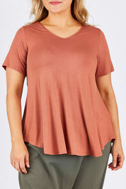 Model Ljubenka wearing size 18 of the Softly Swinging Bamboo Tee in colour Copper, from the front, cropped image