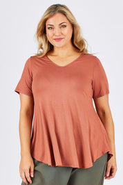 Model Ljubenka wearing size 18 of the Softly Swinging Bamboo Tee in colour Copper, from the front, cropped image