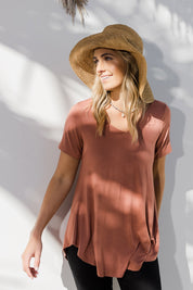 Model Tegan wearing size 10 of the Softly Swinging Bamboo Tee in colour Copper, from the front, showing the whole outfit