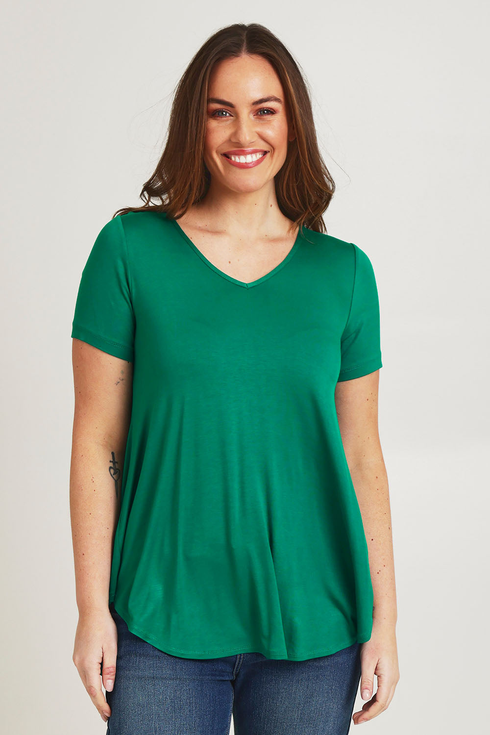 Model Jane wearing size 14 of the Softly Swinging Bamboo Tee in colour Lushgreen (Green), from the front, cropped image